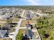 An aerial view of a single Gathering home with fenced yard, showcasing lush landscaping and neighborhood charm at 747 Fraser Ct, Kissimmee, FL 34759