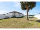 The fenced backyard features ample space and a mature palm tree adding character to the outdoor area at 747 Fraser Ct, Kissimmee, FL 34759