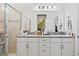 Bright bathroom featuring a double vanity, granite countertop, modern lighting, and a glass-enclosed shower at 747 Fraser Ct, Kissimmee, FL 34759