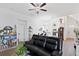 Bright open concept living room with hardwood floors, ceiling fan, and ample natural light at 747 Fraser Ct, Kissimmee, FL 34759