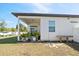 Covered patio is accented with potted plants and provides outdoor living space with access through a sliding glass door at 747 Fraser Ct, Kissimmee, FL 34759