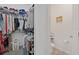 Walk-in closet filled with many articles of clothing; toilet room next door at 747 Fraser Ct, Kissimmee, FL 34759