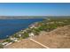 Aerial view of a lakeside home nestled among mature trees, offering serene water views and a private setting at 819 Seminole Rd, Babson Park, FL 33827