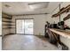 Unfinished basement featuring concrete block walls, sliding glass door, and access to the outdoors at 819 Seminole Rd, Babson Park, FL 33827