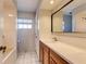 Bathroom featuring a wood vanity with a white countertop, tiled floor, and shower at 819 Seminole Rd, Babson Park, FL 33827