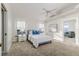 Bright bedroom featuring a comfortable bed, soft carpet, and windows with natural light at 819 Seminole Rd, Babson Park, FL 33827