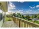 Wooden deck showcasing a beautiful water view, surrounded by lush greenery and a clear blue sky at 819 Seminole Rd, Babson Park, FL 33827
