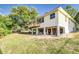 The rear exterior shows an elevated deck, partial basement, and expansive green space at 819 Seminole Rd, Babson Park, FL 33827
