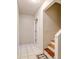 Hallway view featuring stairs with wooden treads, light tile flooring, and a painted block wall at 819 Seminole Rd, Babson Park, FL 33827