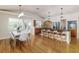 Open concept kitchen with island seating, dining area, stainless steel appliances, and ample cabinet space at 819 Seminole Rd, Babson Park, FL 33827
