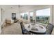 Bright sunroom with water views, plenty of seating and a game table for entertaining friends at 819 Seminole Rd, Babson Park, FL 33827