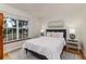 Bright main bedroom with hardwood floors, natural light, and a comfortable bed at 819 Seminole Rd, Babson Park, FL 33827