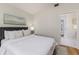 Comfortable main bedroom with a soft color palette and access to an ensuite bathroom at 819 Seminole Rd, Babson Park, FL 33827