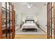 Serene main bedroom featuring hardwood floors, a comfortable bed, and stylish decor at 819 Seminole Rd, Babson Park, FL 33827