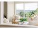 Cozy sitting area featuring comfortable armchairs, natural light, and scenic outdoor views at 819 Seminole Rd, Babson Park, FL 33827