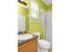 Well-lit bathroom with vanity, toilet, and glass-enclosed shower at 908 Orista Dr, Davenport, FL 33897