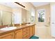 Well-lit bathroom featuring double sinks, a soaking tub, and a separate shower at 908 Orista Dr, Davenport, FL 33897