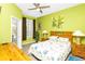 Sunny bedroom with colorful comforter, bedside lamps, and outdoor access at 908 Orista Dr, Davenport, FL 33897