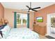 Comfortable bedroom with dresser, TV, outdoor access, and ceiling fan at 908 Orista Dr, Davenport, FL 33897