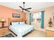Bright bedroom features a bed with decorative pillows and a ceiling fan at 908 Orista Dr, Davenport, FL 33897