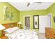 Green bedroom featuring a decorative bed, art, and an en suite bathroom at 908 Orista Dr, Davenport, FL 33897