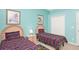 Bright bedroom with two twin beds, light blue walls, and closet at 908 Orista Dr, Davenport, FL 33897