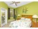 Bright bedroom with comfortable bed, bedside lamps, and outdoor access at 908 Orista Dr, Davenport, FL 33897