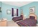 Bright bedroom featuring two twin beds and a window at 908 Orista Dr, Davenport, FL 33897