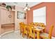 Bright dining room with a dining table set for six, complemented by warm natural lighting at 908 Orista Dr, Davenport, FL 33897