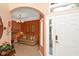 Warm and inviting foyer with tiled flooring, leading to a comfortable living area with a cozy sofa at 908 Orista Dr, Davenport, FL 33897