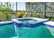 Enjoy the luxurious hot tub with spa and a lush tropical view at 908 Orista Dr, Davenport, FL 33897