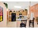 Charming kitchen featuring wood cabinets and black appliances plus a breakfast bar at 908 Orista Dr, Davenport, FL 33897