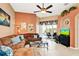Cozy living room with a comfortable sofa, a ceiling fan, a view of the pool through sliding glass doors, and stylish decor at 908 Orista Dr, Davenport, FL 33897