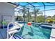 A screened-in pool with a spa and lush landscaping at 908 Orista Dr, Davenport, FL 33897