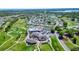 Beautiful aerial view of a community with a golf course, swimming pool, tennis courts, and nearby lakes at 1055 Canary S Cir, Lakeland, FL 33809