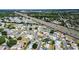 Scenic neighborhood adjacent to a major highway, featuring sidewalks and lush landscaping at 1055 Canary S Cir, Lakeland, FL 33809
