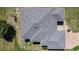 Birds-eye view of a roof with solar panels and a screened in patio area at 1055 Canary S Cir, Lakeland, FL 33809