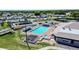 Aerial view featuring a community pool, tennis courts, and surrounding neighborhood at 1055 Canary S Cir, Lakeland, FL 33809