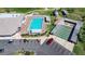 Aerial view showcasing the community pool, shuffleboard courts, and parking areas at 1055 Canary S Cir, Lakeland, FL 33809