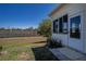 Well-maintained backyard with a privacy wall, a grassy lawn, and a view of the side of the home at 1055 Canary S Cir, Lakeland, FL 33809