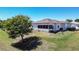 Backyard view with a well-maintained lawn, minimal landscaping, and the home's screened in porch at 1055 Canary S Cir, Lakeland, FL 33809
