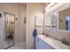 Bathroom with double sinks, vanity, linen closet and mirrors at 1055 Canary S Cir, Lakeland, FL 33809