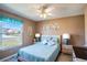 Cozy bedroom with a queen bed, ceiling fan, and neutral tones at 1055 Canary S Cir, Lakeland, FL 33809