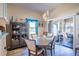 Elegant dining area with stylish lighting, coastal decor, and sliding door to the lanai at 1055 Canary S Cir, Lakeland, FL 33809