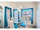 Bright breakfast nook features a glass table with seating and decorative turquoise accents at 1055 Canary S Cir, Lakeland, FL 33809
