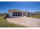 Charming home with a two-car garage featuring a large screened garage door and a brick paver driveway at 1055 Canary S Cir, Lakeland, FL 33809