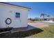 The side of the home with a paver walkway and a landscaped front yard with well-maintained grass at 1055 Canary S Cir, Lakeland, FL 33809