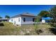 Exterior shot showing a well-maintained lawn, minimal landscaping, and the home's screened in porch at 1055 Canary S Cir, Lakeland, FL 33809