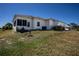 A view of the back of the home showing a screened in patio and green space at 1055 Canary S Cir, Lakeland, FL 33809