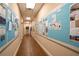 Well lit hallway with bulletin boards full of community postings and a view into the back at 1055 Canary S Cir, Lakeland, FL 33809
